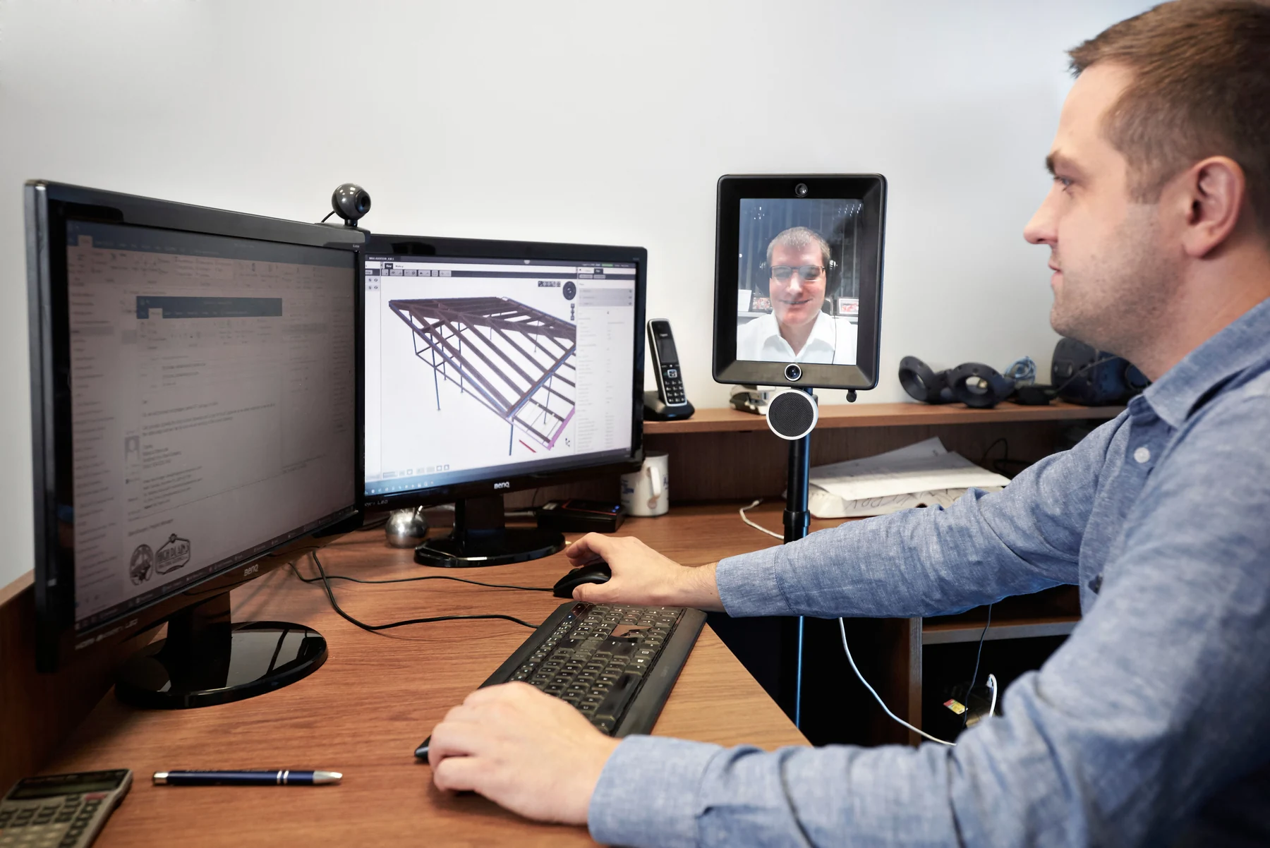 Anatomic detailer working with a steel model and a remote colleague